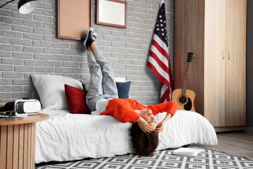 Wall Mural - Female student lying on bed in bedroom