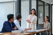 © crizzystudio - New-generation businessmen, creative professionals, and accountants meet to discuss business, brainstorm ideas, and project analysis reports. Check online investment results and company profits.