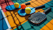 A close-up shot of pickleball paddles and balls on a colorful court, ready for play, showcasing the equipment and setup for a game of pickleball