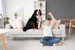 Little boy with Bernese mountain dog watching TV at home