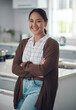 © peopleimages.com - Happy, asian woman and arms crossed, thinking in portrait for cooking new recipe in kitchen. Happiness, female person and smile with casual outfit for wellness, home decoration and fresh apartment