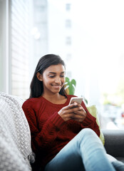 Poster - Relax, home and Indian woman on couch with phone for social media, networking or reading on weekend. Happy, scroll and girl on sofa or smartphone for communication, online chat or smile in lounge