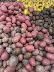 Wall Mural - Pink potatoes on a market counter as a background. Texture