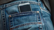 Mobile phone with blank black background in back pocket jeans.