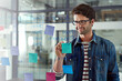 © peopleimages.com - Business, glass and man writing, planning and graphic designer with ideas and brainstorming for schedule. Person, artist and freelancer with sticky note, creativity and entrepreneur with deadline