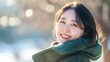 Smiling Young Woman in Teal Coat Enjoying Sunny Winter Day