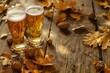 Two glasses of beer and autumn leaves on a wooden background,  Close-up