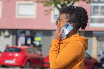 Wall Mural - urban black woman with phone on the street