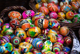 Fototapeta Mapy - Decorated Easter eggs on sale at the Easter fair bazaar stall, traditional market stand in Poland. Collection of colourful painted Paschal eggs. Wooden pisanki egg decorations.