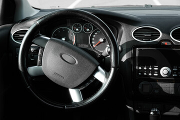 Black steering wheel and dashboard in car