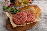Fototapeta Kuchnia - Raw burger cutlet for grill