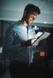 © peopleimages.com - Happy, businessman and night with tablet for research, networking or tech support at office. Young man, employee or IT specialist working late on technology for online maintenance at workplace