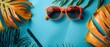Retro Vibes: Vintage Eyewear & Tropical Foliage on Pastel Blue. Concept Vintage Eyewear, Tropical Foliage, Pastel Blue, Retro Vibes