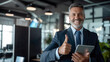 Cheerful and encourage businessman thumbs up posing and smiling at camera in office.