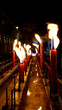 Many burning lighting candles in the temple at night 