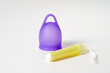 Hygiene Solutions: Purple Menstrual Cup and Tampon Side by Side