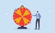 Xcite businessman looking at spinning fortune wheel waiting for luck, life depend on luck, fortune wheel randomness, chance and opportunity to get new job, investment winning or gambling concept