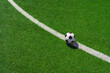 a soccer ball on the green grass in soccer stadium.