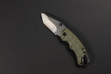 Wall Mural - tactical folding knife. EDC knife. on dark background