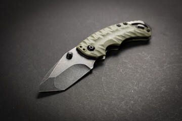 Wall Mural - tactical folding knife. EDC knife. on dark background