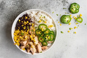 Wall Mural - Chipotle spicy chicken lunch bowl with rice corn, beans, rice and jalapenos