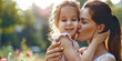© britaseifert - Mother and daughter bonding. Loving family connection, parent-child closeness. Cute little preschooler daughter hug cuddle with smiling young mother kiss