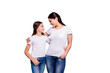Close up photo amazing pretty two people brown haired mum small little daughter stand close hugging lovely look eyes rejoice wearing white t-shirts isolated on bright blue background