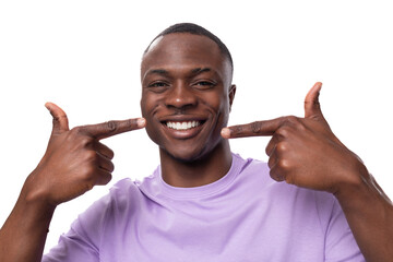 Wall Mural - close-up portrait of a young proud american man dressed in a light lilac t-shirt on a white background with copy space