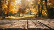An autumn backdrop frames an unoccupied wooden table