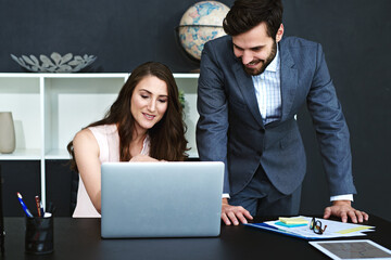 Canvas Print - Happy, business people and laptop with documents for finance, teamwork or planning at office. Young businessman and woman with smile on computer for financial budget, accounting or tasks at workplace