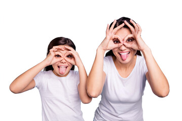 Wall Mural - Close up photo beautiful two people brown haired mom little daughter best friends look through finger glasses specs okey symbol tongue out mouth wearing white t-shirts isolated bright blue background