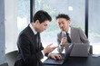 © kapinon - Senior male businessman company employee gently instructing junior employees, training new employees and mentoring newcomers in the company.