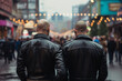 Back view of two men with shaved heads and in leather jackets in street