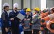 © Nassorn - Robotic engineer team standing together meeting at factory discussing electronic robot machine engineering. AI high tech production technician teamwork working at futuristic technology manufacturing