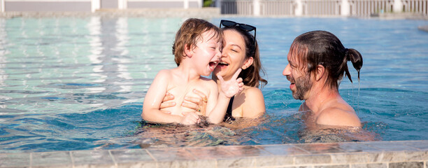 caucasian family having enjoy and fun together with happiness in swimming pool, summer and holiday, 