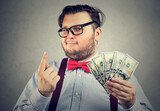 Fototapeta Do przedpokoju - Portrait of a sly looking businessman with hundred dollar bills giving one piece of advice