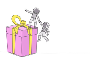 Poster - Single one line drawing young astronaut helps colleague climb the big gift box. Integrated teamwork to reach highest level for rewards. Helping each other. Continuous line design graphic illustration