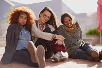 Poster - Portrait, female student and floor of campus, break and relax for classes at university. Face, happy and diverse friends at school and education for women learners, academics and learning at college