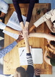 © peopleimages.com - Creative people, hands together and teamwork with documents above for collaboration, support or trust at office. Top view of group or employees piling with paperwork for agreement, meeting or startup