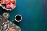 Fototapeta Sypialnia - Traditional Turkish coffee and Turkish delight on a painted dark blue-green wooden background
