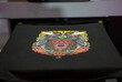© Itsanan - Sublimation printer printing T shirt show in Garment and Textile Manufacturing Industry.