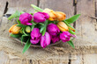 colorful tulips on wooden background - close up