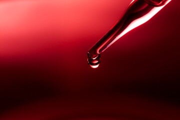 Wall Mural - macro science experiment, water drops, liquid dripping from glass pipette in red laboratory