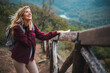 © Dragana Gordic - Photo of a young smiling woman carrying a backpack and hiking in the nature. Young woman breathing pure air in a forest. Happy hiker caucasian woman smile and enjoy the nature walking