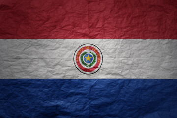 big national flag of paraguay on a grunge old paper texture background