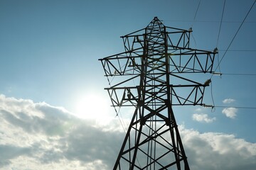 Wall Mural - Telephone pole and wires against blue sky with clouds