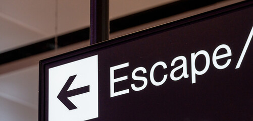 Wall Mural - Escape partially written on black sign 