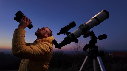 Wall Mural - amateur astronomer looking at the evening skies, observing planets, stars, moon and other celestial 