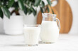 glass and jug of milk in a bright kitchen, dairy products, calcium