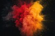 Explosion of powder in the form of a cloud of colors red and yellow on a black background